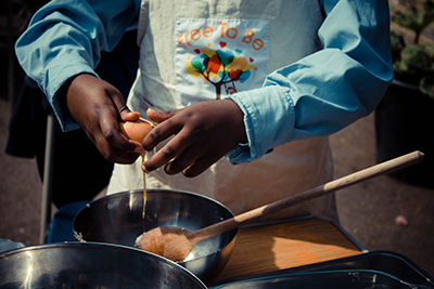 IF Trust partner charity Free to be Kids - cooking an outdoor meal.